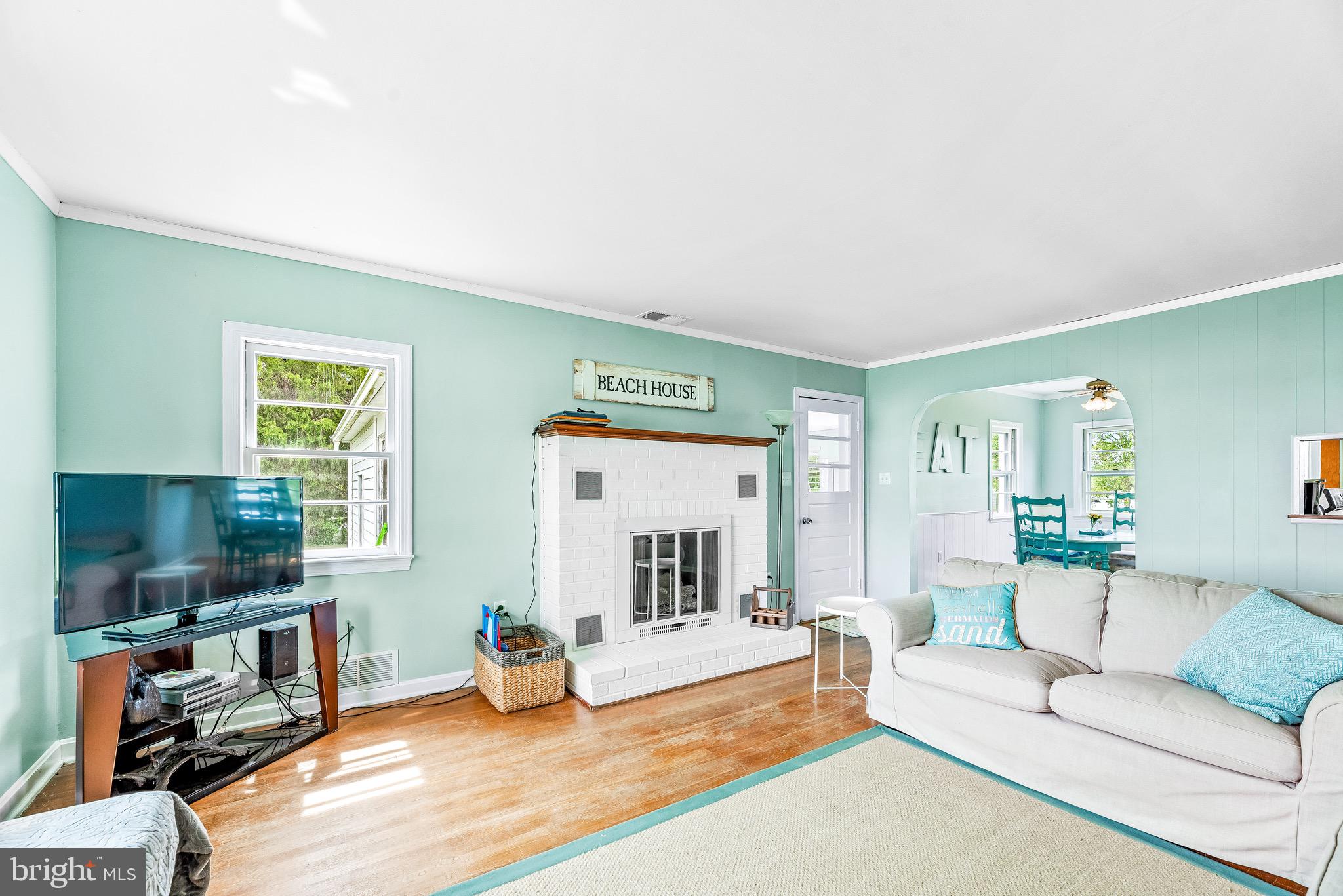 16410 Fishermen Way Ridge, MD 20680 - Photo 6 of 34 a living room with furniture and a flat screen tv
