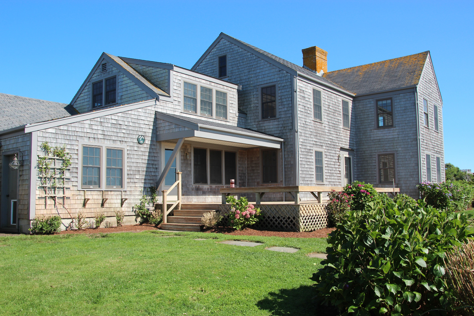 142 Miacomet Road Nantucket, MA 02554 - Photo 1 of 21 a front view of house with yard and outdoor seating
