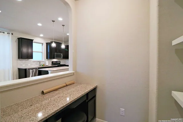 a view of a hallway with wooden floor and a living room