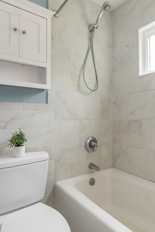 79 Mill Street Natick, MA 01760 - Photo 12 of 21 a white toilet sitting next to a bath tub shower