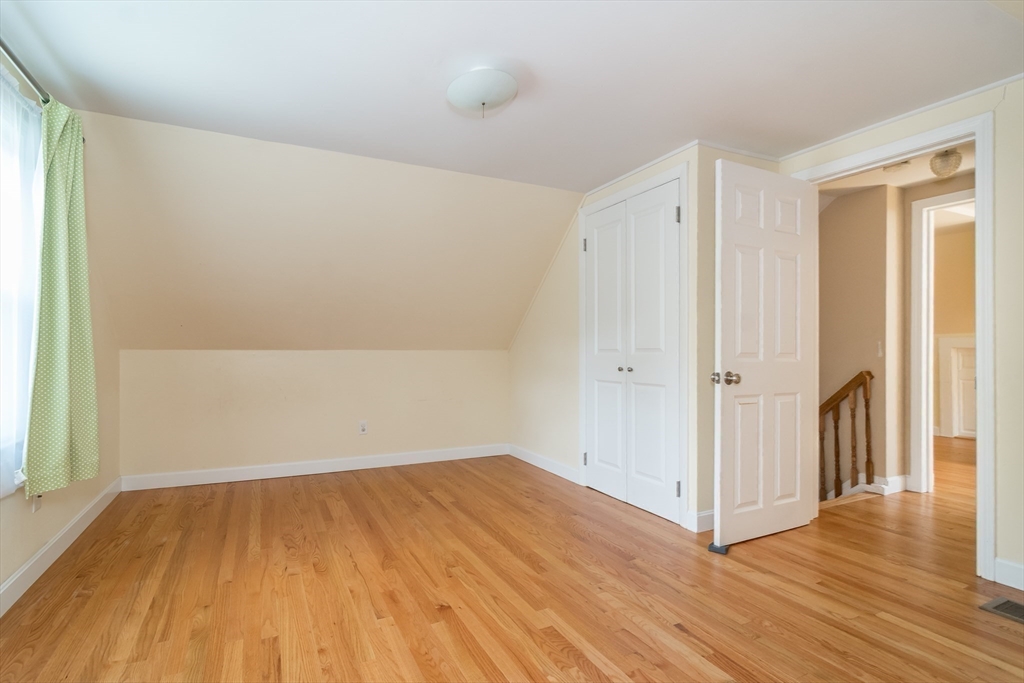 79 Mill Street Natick, MA 01760 - Photo 13 of 21 an empty room with wooden floor and windows