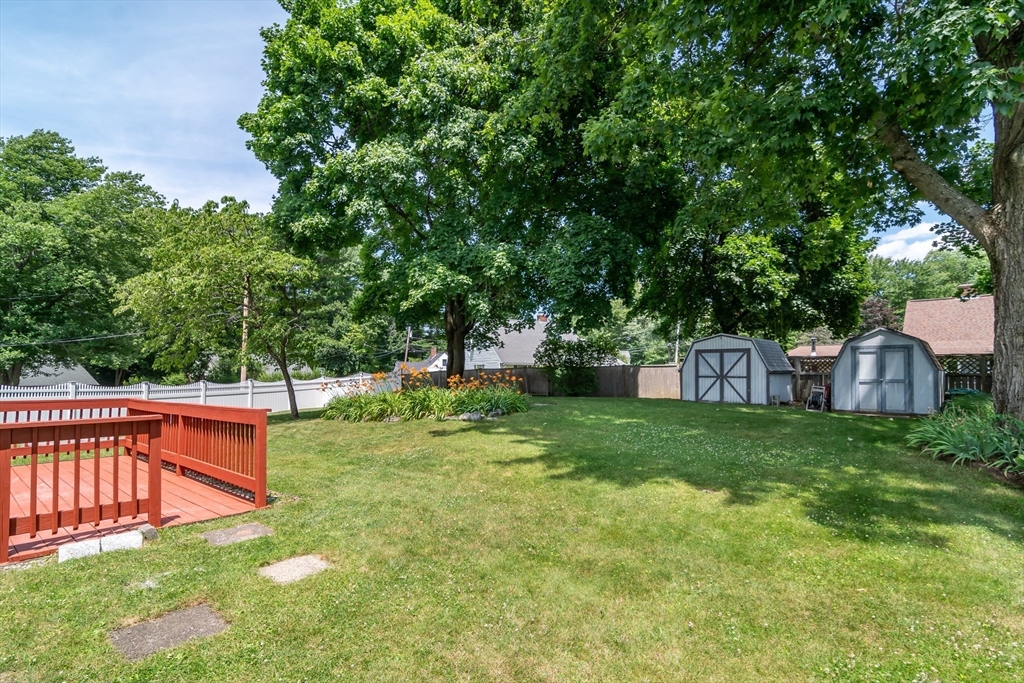 79 Mill Street Natick, MA 01760 - Photo 18 of 21 a backyard of a house with trees and plants