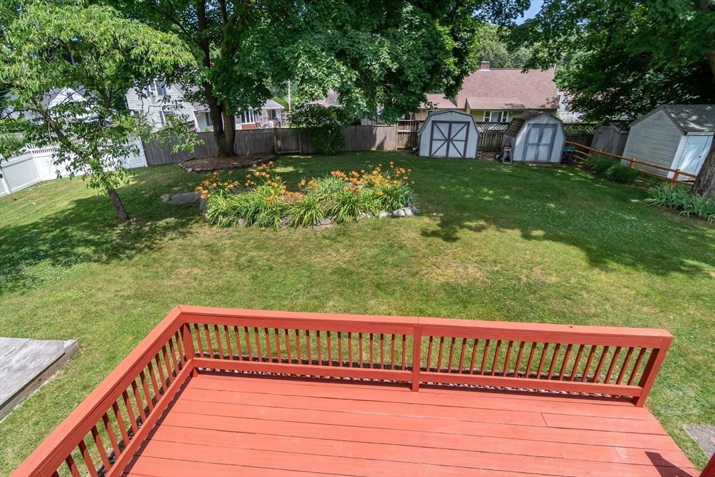 79 Mill Street Natick, MA 01760 - Photo 19 of 21 a view of a wooden deck with a yard