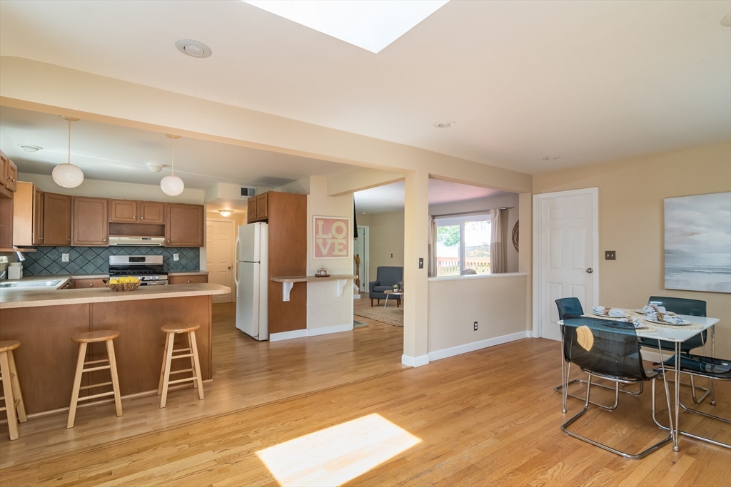 79 Mill Street Natick, MA 01760 - Photo 2 of 21 a living room with stainless steel appliances kitchen island granite countertop furniture and a wooden floor