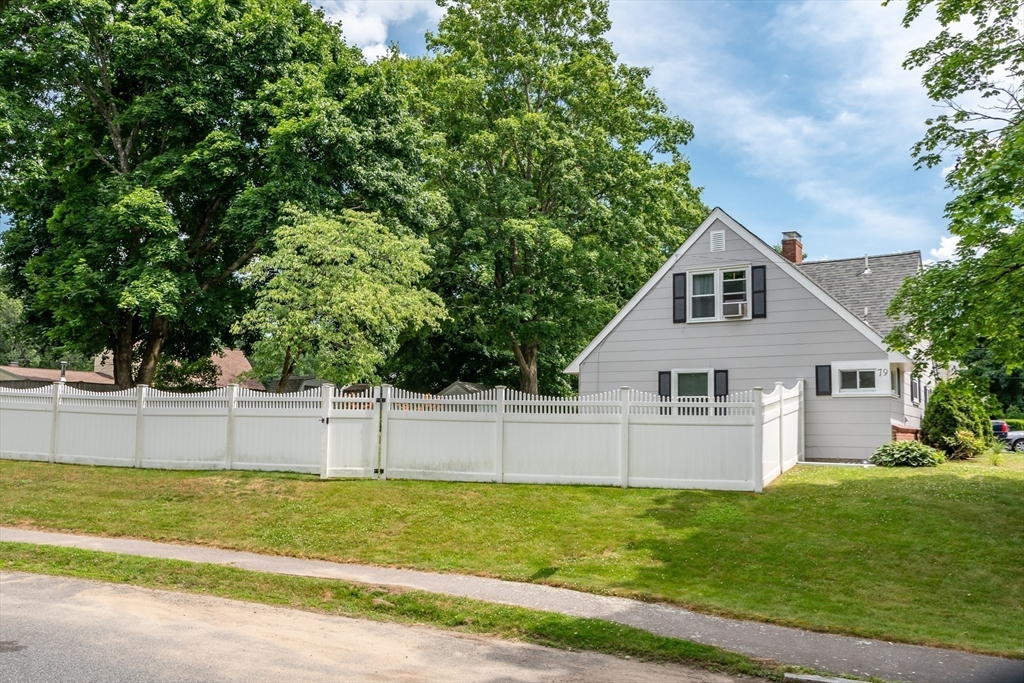 79 Mill Street Natick, MA 01760 - Photo 21 of 21 a view of a backyard with large trees and plants