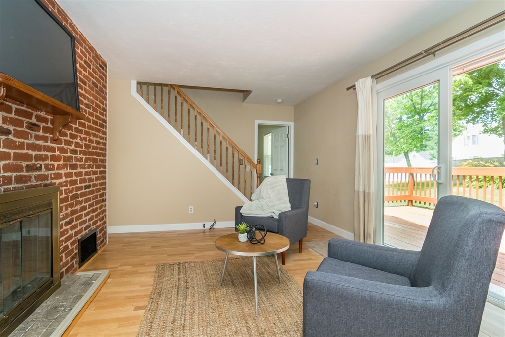 79 Mill Street Natick, MA 01760 - Photo 8 of 21 a living room with furniture and a fireplace