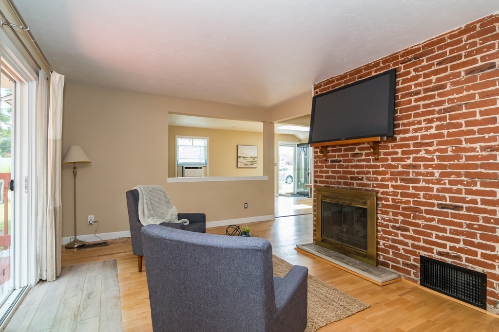 79 Mill Street Natick, MA 01760 - Photo 9 of 21 a living room with furniture and a fireplace
