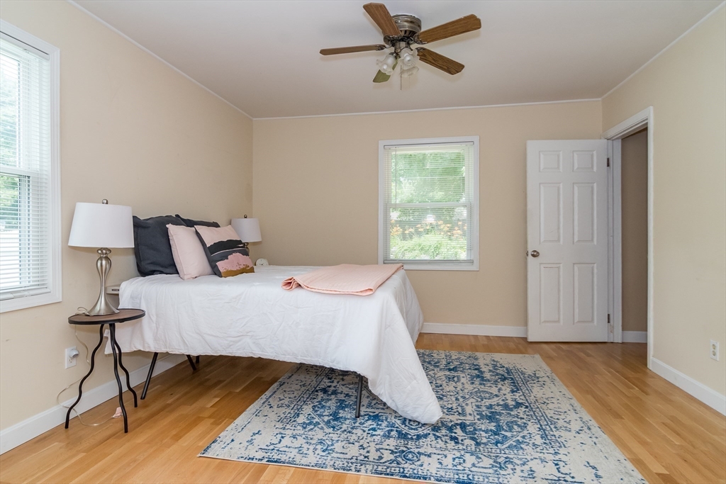 79 Mill Street Natick, MA 01760 - Photo 10 of 21 a bedroom with a bed rug and wooden floor