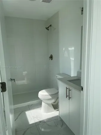 a bathroom with a shower and a toilet