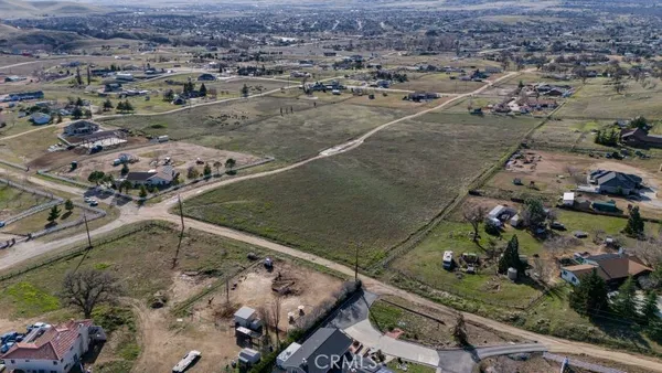 an aerial view of a residential houses with outdoor space