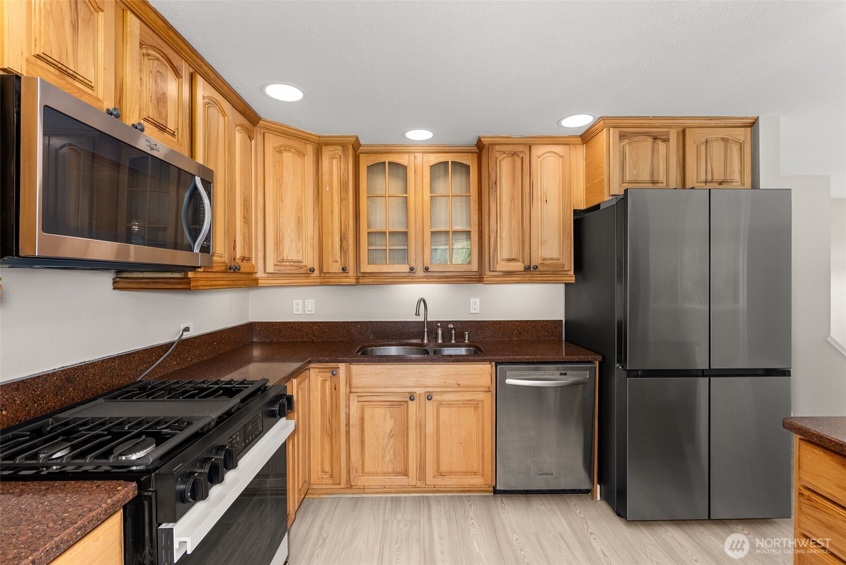 269 Elk Creek Road Raymond, WA 98577 - Photo 7 of 38 a kitchen with granite countertop a refrigerator stove top oven and sink
