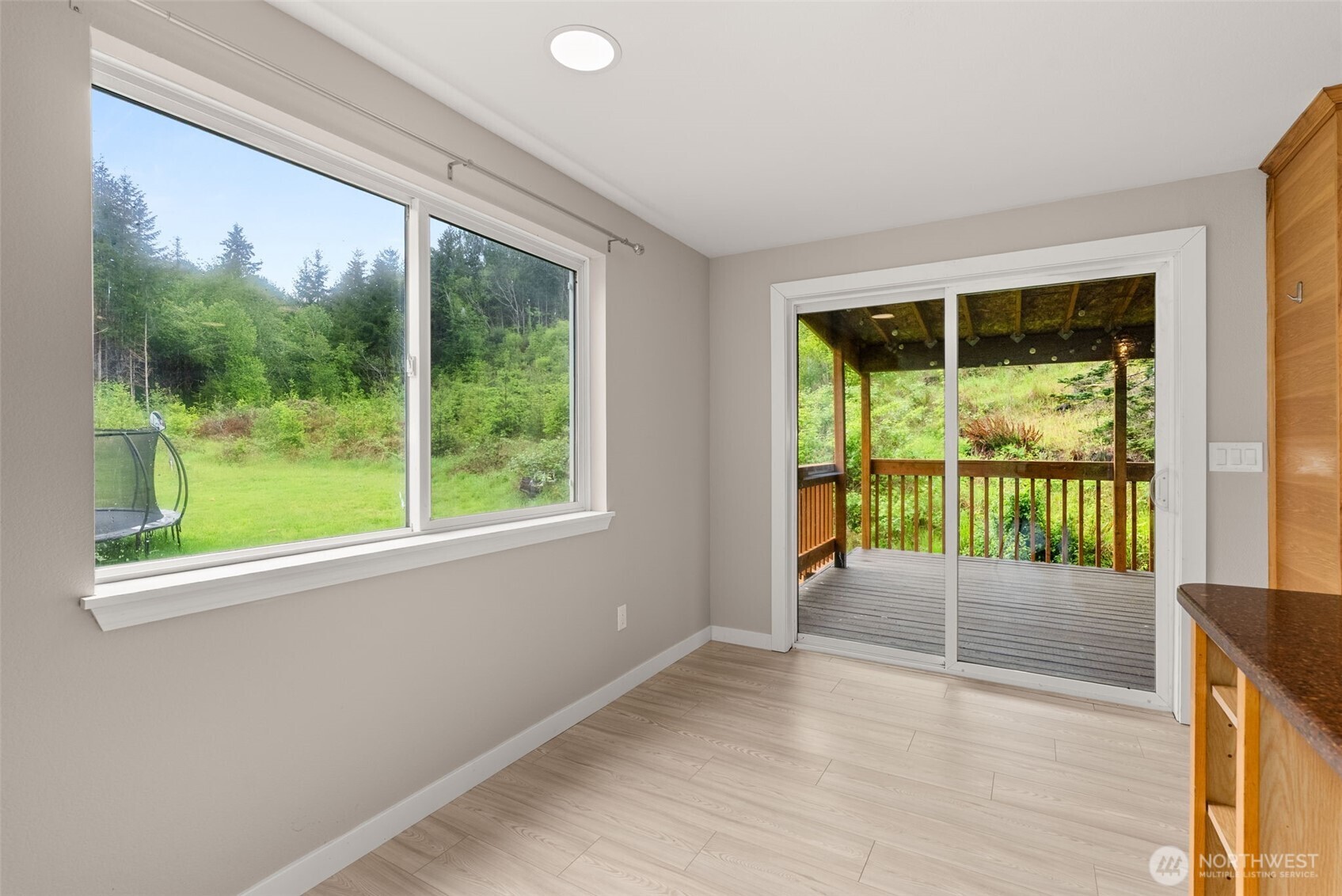269 Elk Creek Road Raymond, WA 98577 - Photo 9 of 38 a view of an empty room with wooden floor and a window