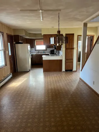 a kitchen with stainless steel appliances granite countertop a refrigerator and a sink