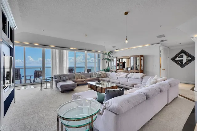 a view of a dining room with furniture and a chandelier