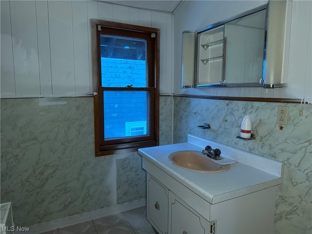 5112 Reed Avenue Ashtabula, OH 44004 - Photo 8 of 21 Bathroom with tile flooring and large vanity