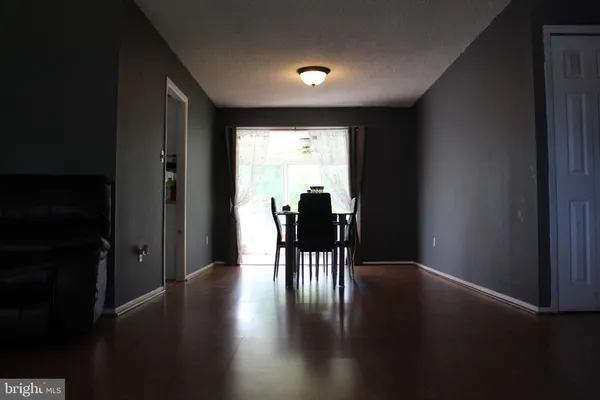 a dining room with furniture and wooden floor