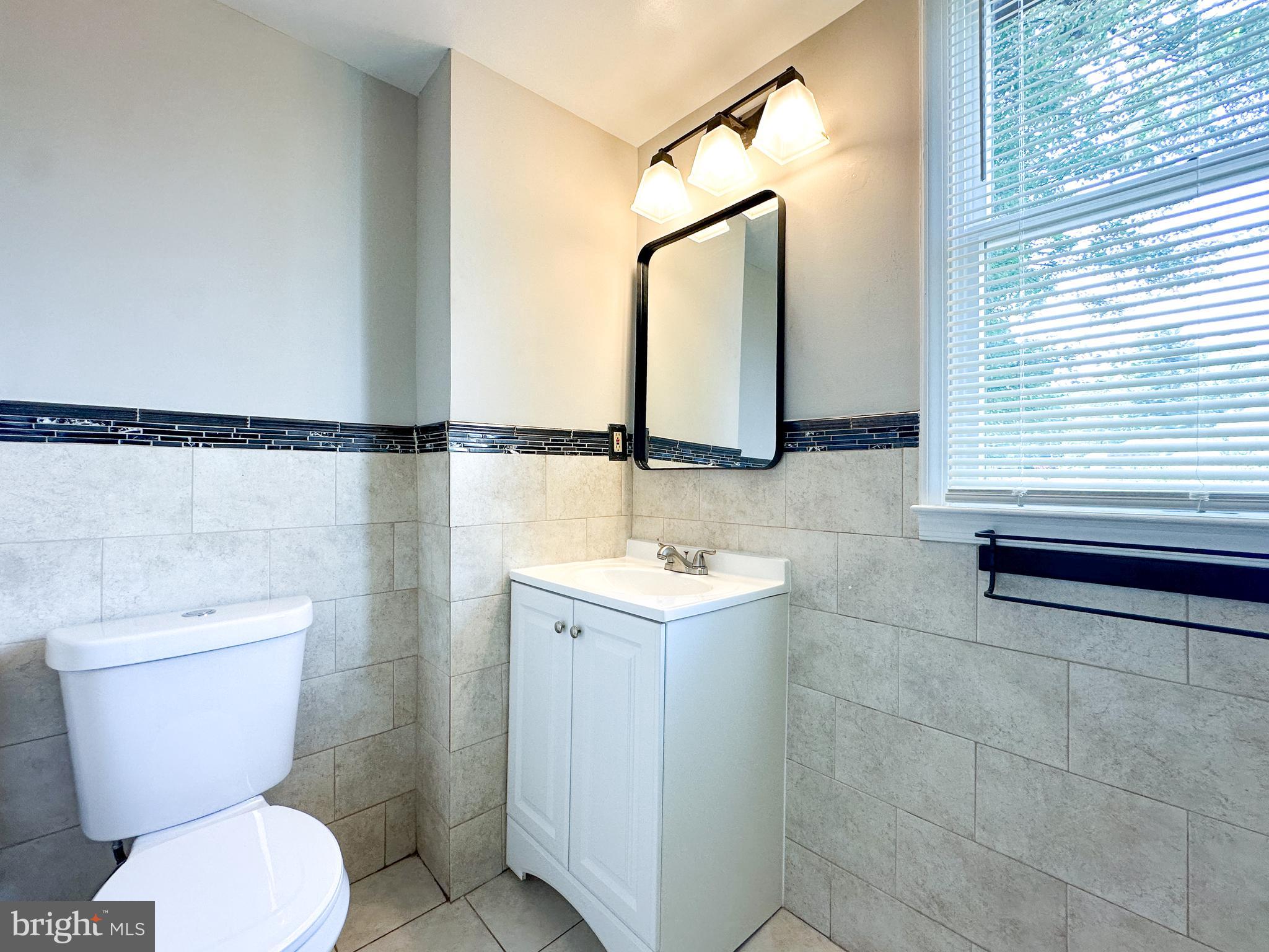 2191 Dunks Ferry Road Bensalem, PA 19020 - Photo 14 of 33 a bathroom with a toilet a sink and a mirror