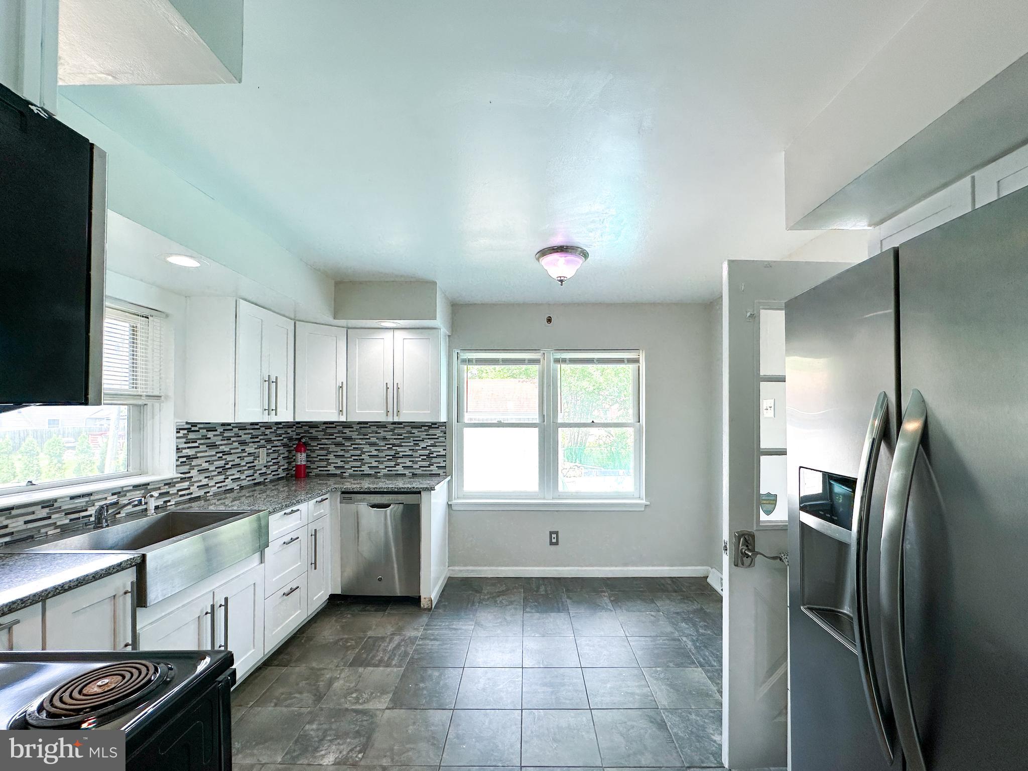 2191 Dunks Ferry Road Bensalem, PA 19020 - Photo 15 of 33 a kitchen with granite countertop a refrigerator stove and sink