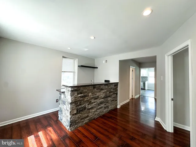 a view of an empty room and wooden floor
