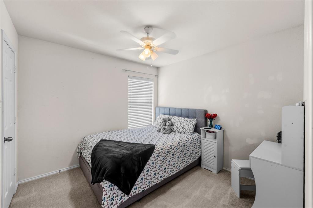9000 Quarry Ridge Trail Fort Worth, TX 76244 - Photo 11 of 32 a bedroom with a bed and a chandelier
