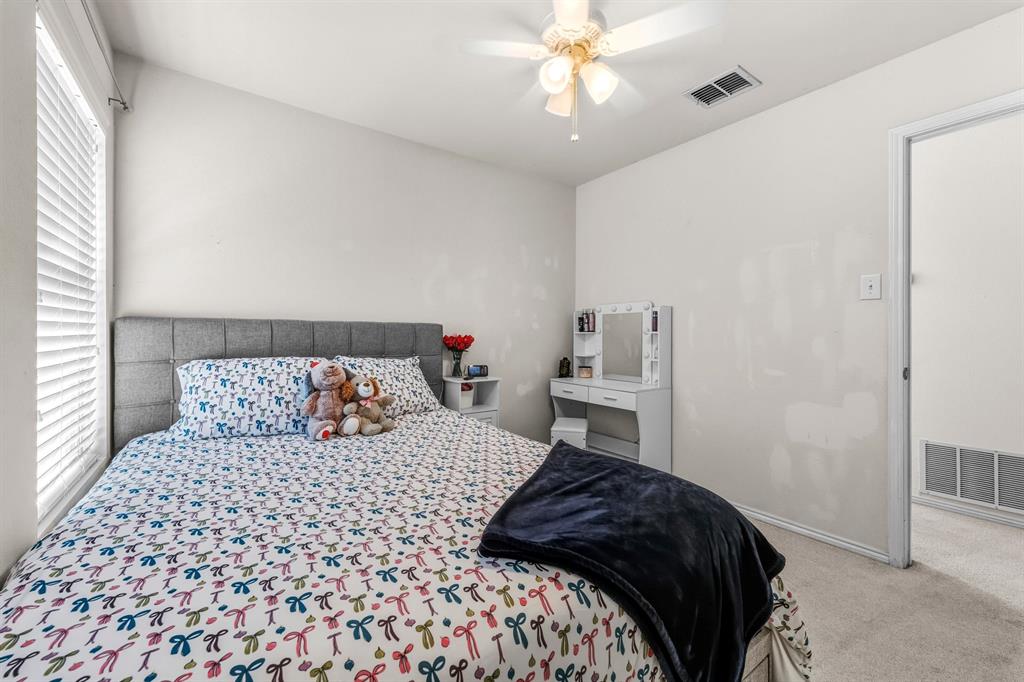 9000 Quarry Ridge Trail Fort Worth, TX 76244 - Photo 12 of 32 a bedroom with a large bed and a chandelier