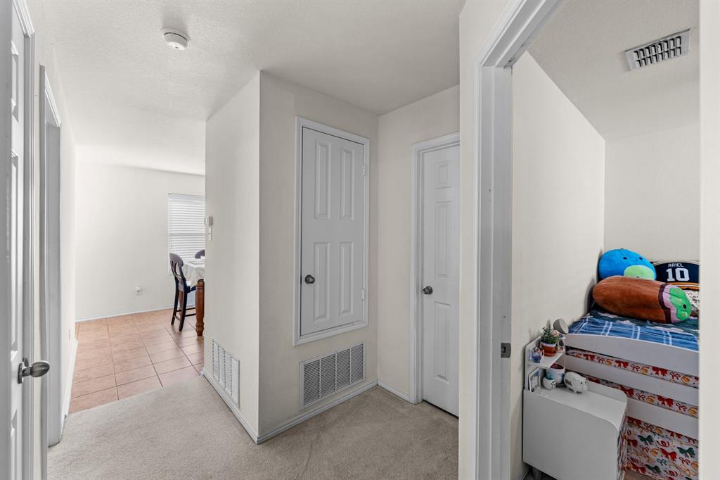 9000 Quarry Ridge Trail Fort Worth, TX 76244 - Photo 16 of 32 a view of a hallway to room with a door and a window