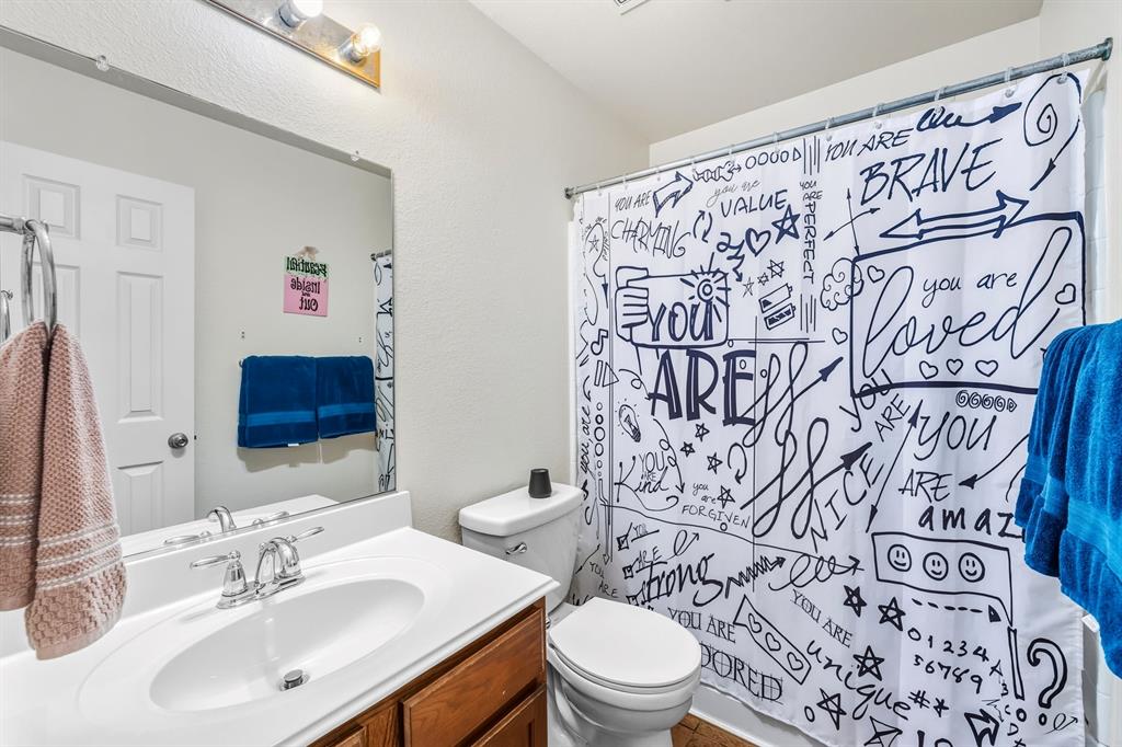 9000 Quarry Ridge Trail Fort Worth, TX 76244 - Photo 19 of 32 a bathroom with a toilet sink and mirror
