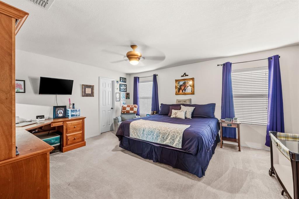 9000 Quarry Ridge Trail Fort Worth, TX 76244 - Photo 3 of 32 a bedroom with a bed and a flat screen tv
