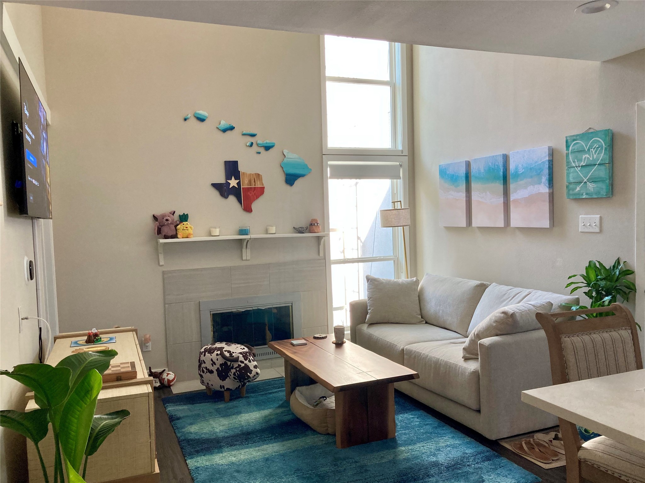a living room with furniture fireplace and a window