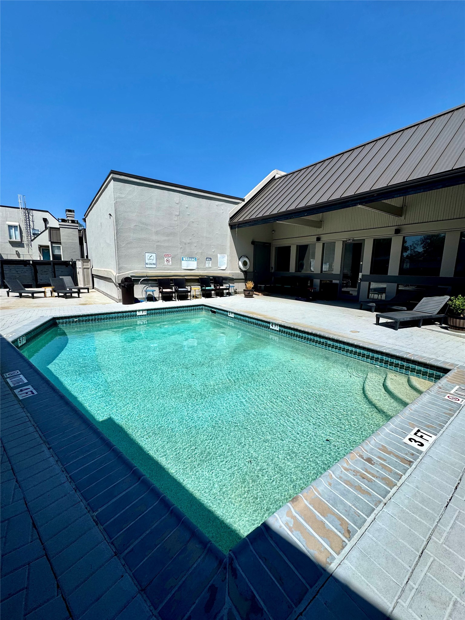 935 La Posada Drive, Unit 252 Austin, TX 78752 - Photo 18 of 20 a view of a house with pool and a yard