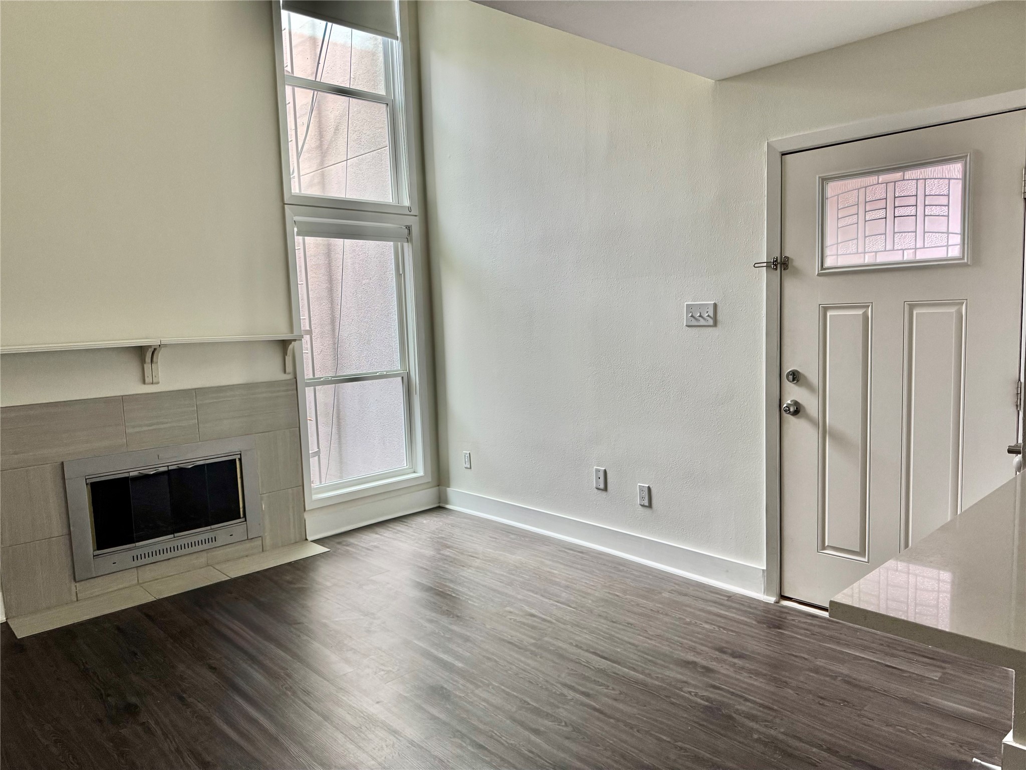 935 La Posada Drive, Unit 252 Austin, TX 78752 - Photo 3 of 20 an empty room with wooden floor and fireplace