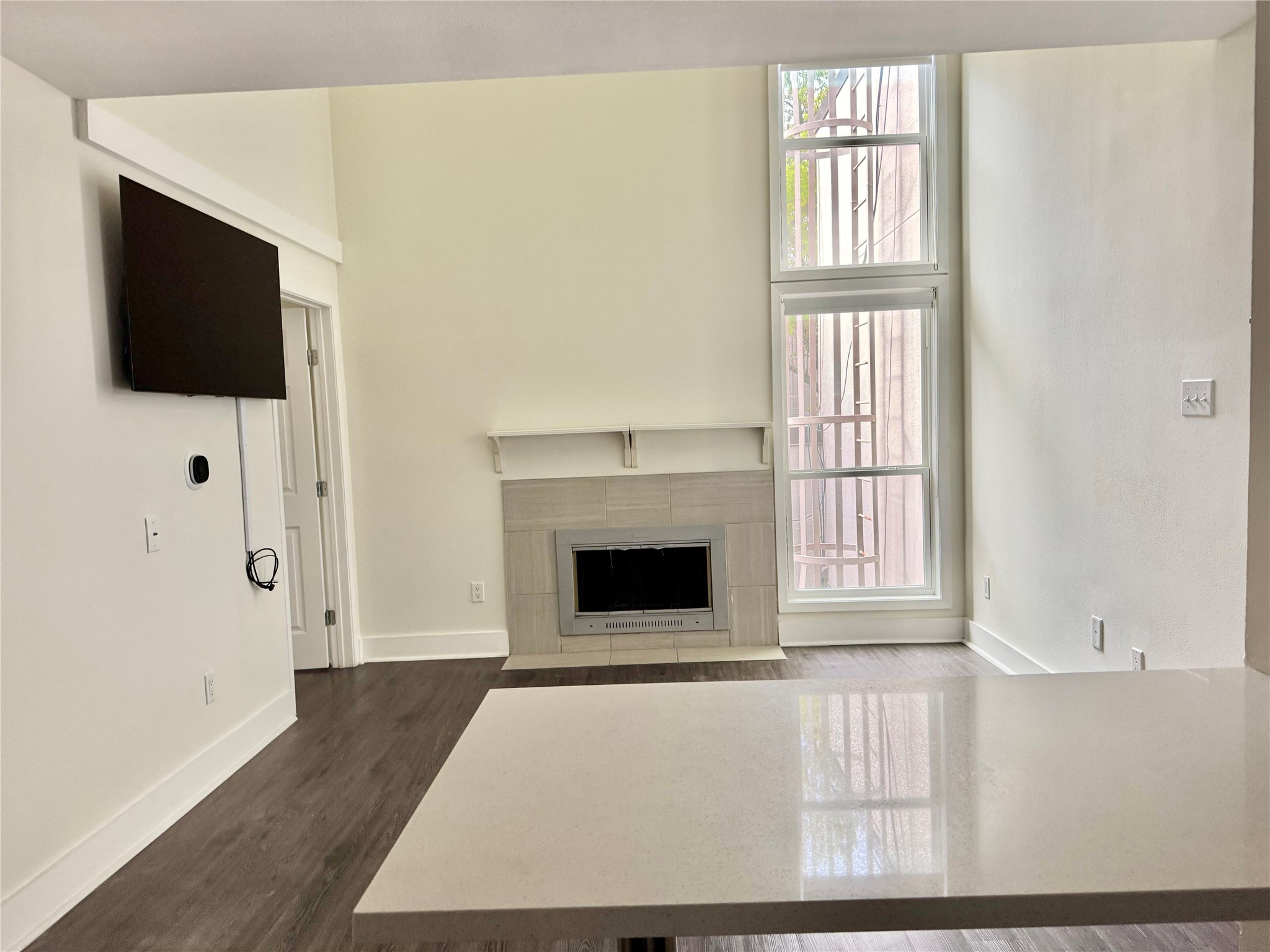 935 La Posada Drive, Unit 252 Austin, TX 78752 - Photo 4 of 20 a living room with a fireplace and a flat screen tv