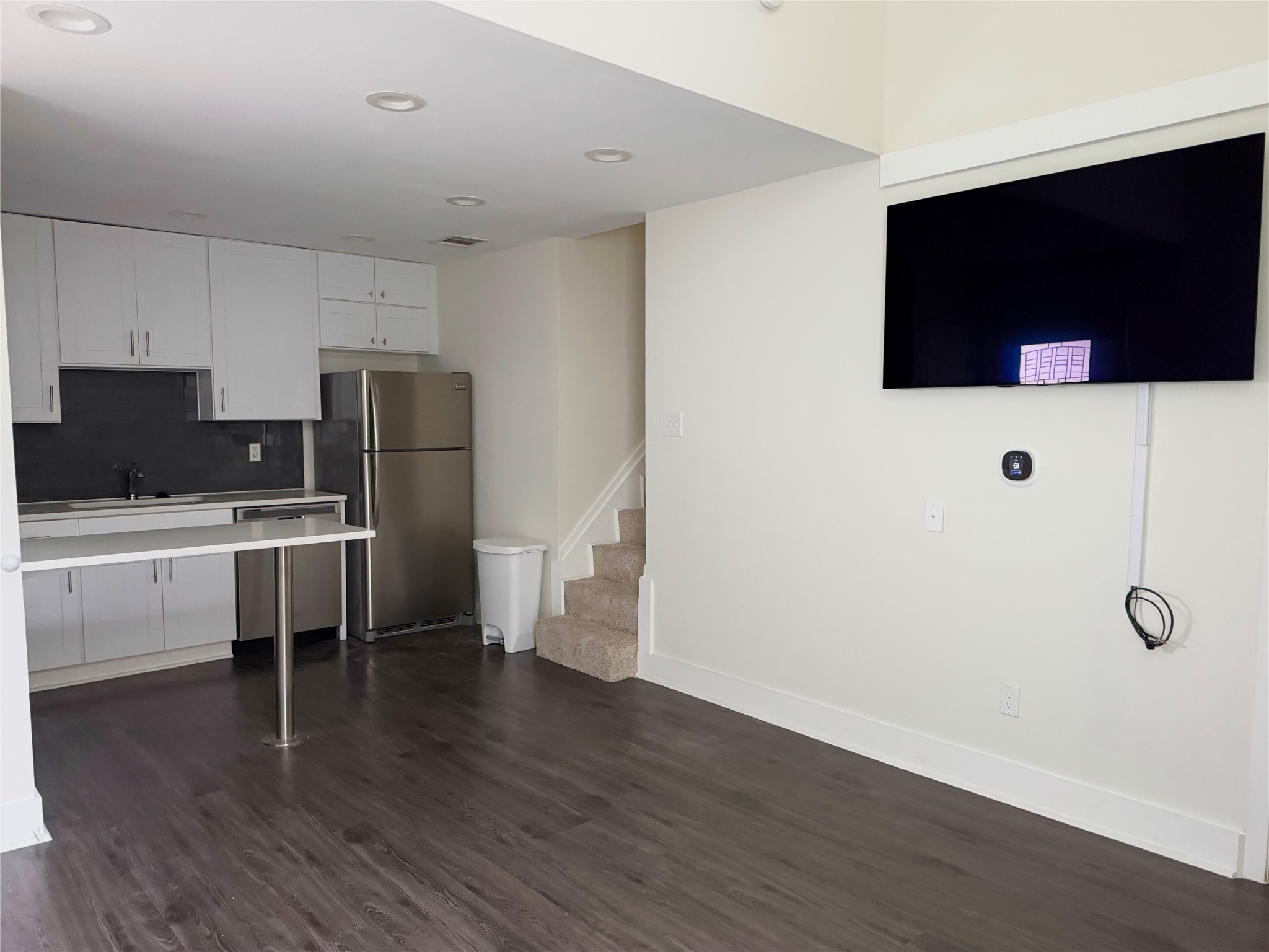 935 La Posada Drive, Unit 252 Austin, TX 78752 - Photo 7 of 20 a view of a kitchen with wooden floor and electronic appliances