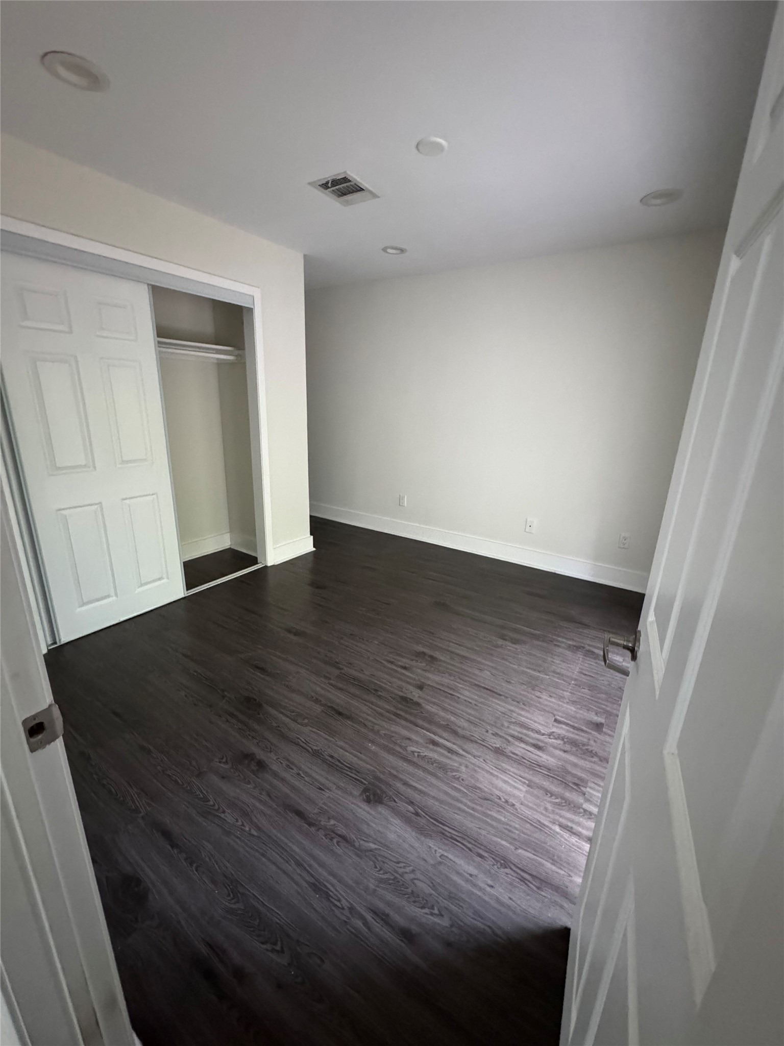 935 La Posada Drive, Unit 252 Austin, TX 78752 - Photo 8 of 20 a view of an empty room with wooden floor and closet