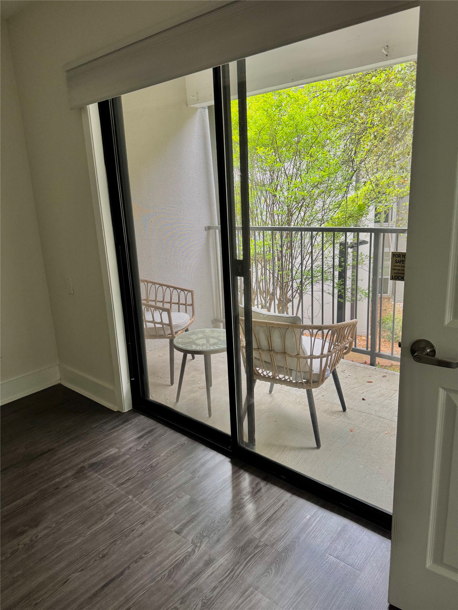 935 La Posada Drive, Unit 252 Austin, TX 78752 - Photo 9 of 20 a view of a hallway with wooden floor and glass door