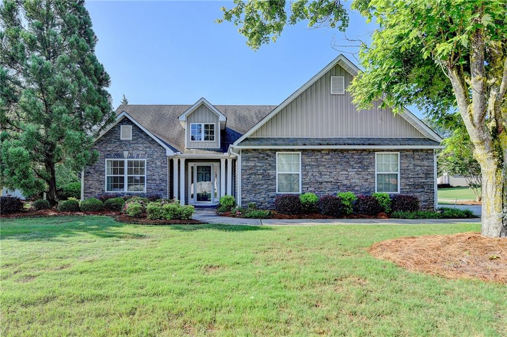 a front view of a house with a yard and garage