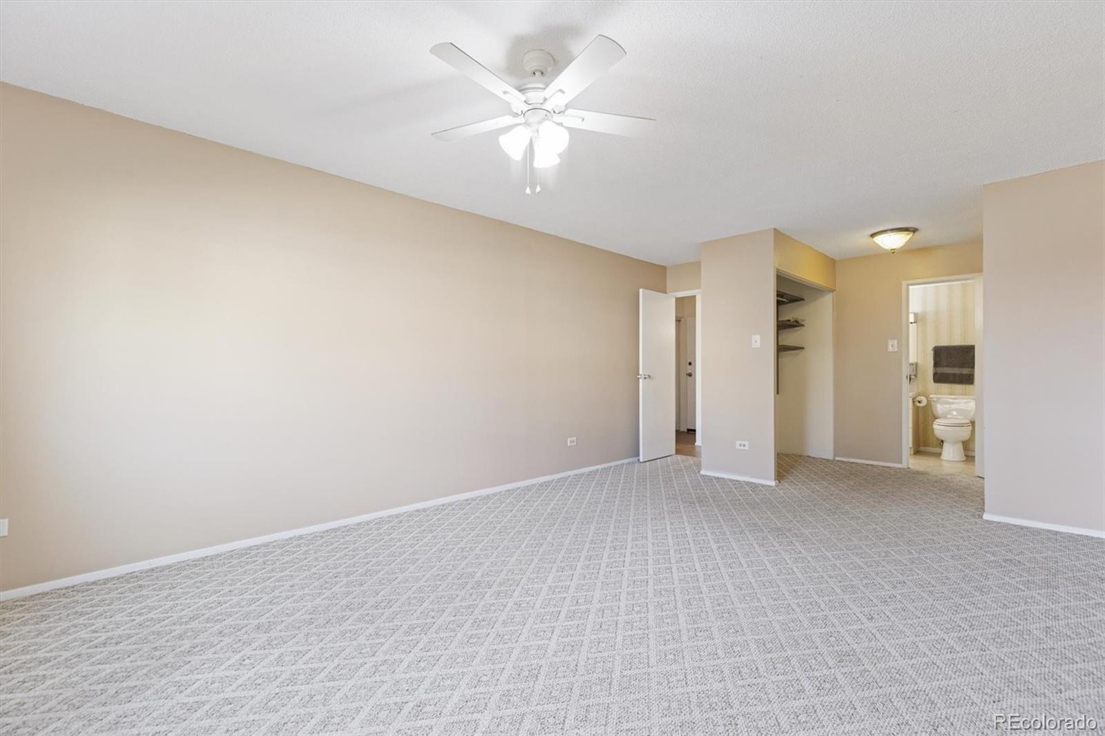 350 South Clinton Street, Unit 8B Denver, CO 80247 - Photo 11 of 50 a view of an empty room with a ceiling fan