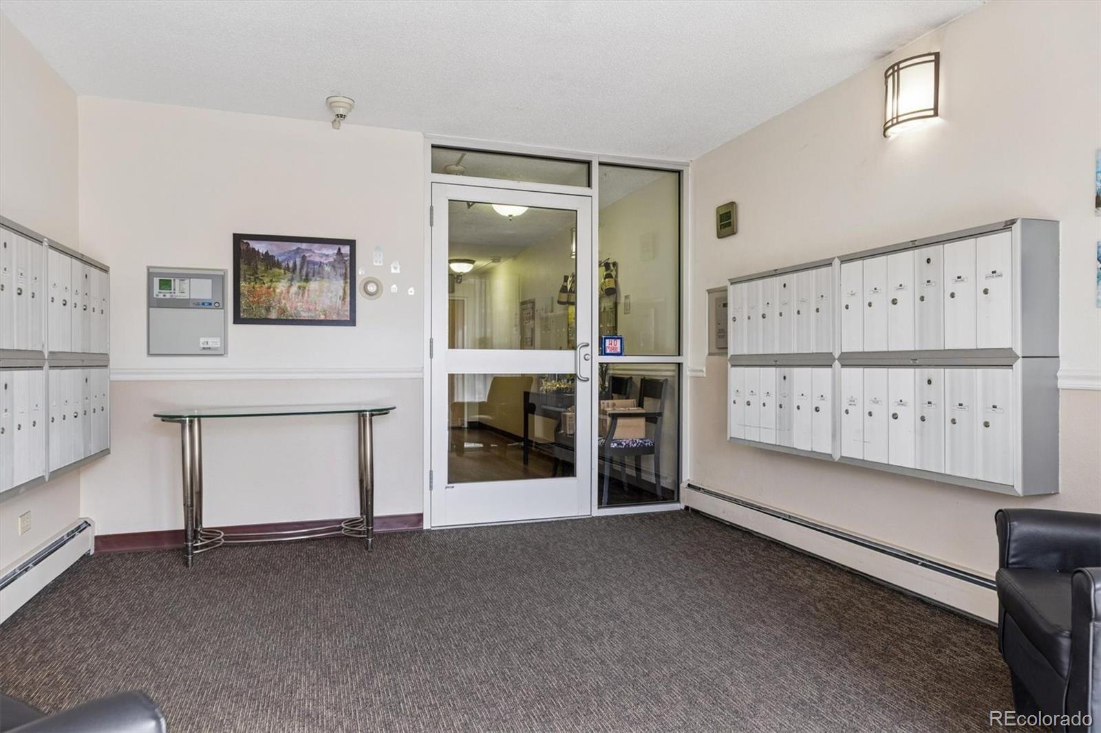 350 South Clinton Street, Unit 8B Denver, CO 80247 - Photo 19 of 50 a view of an empty room with a fireplace