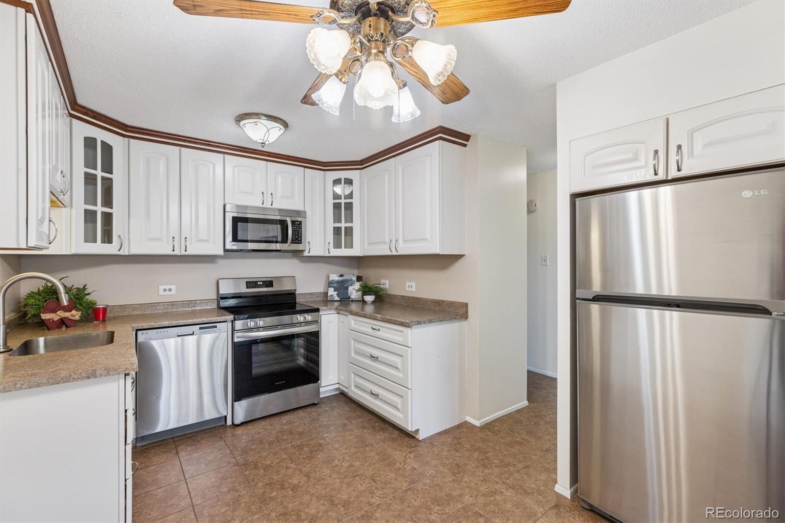 350 South Clinton Street, Unit 8B Denver, CO 80247 - Photo 7 of 50 a kitchen with cabinets stainless steel appliances and a counter space