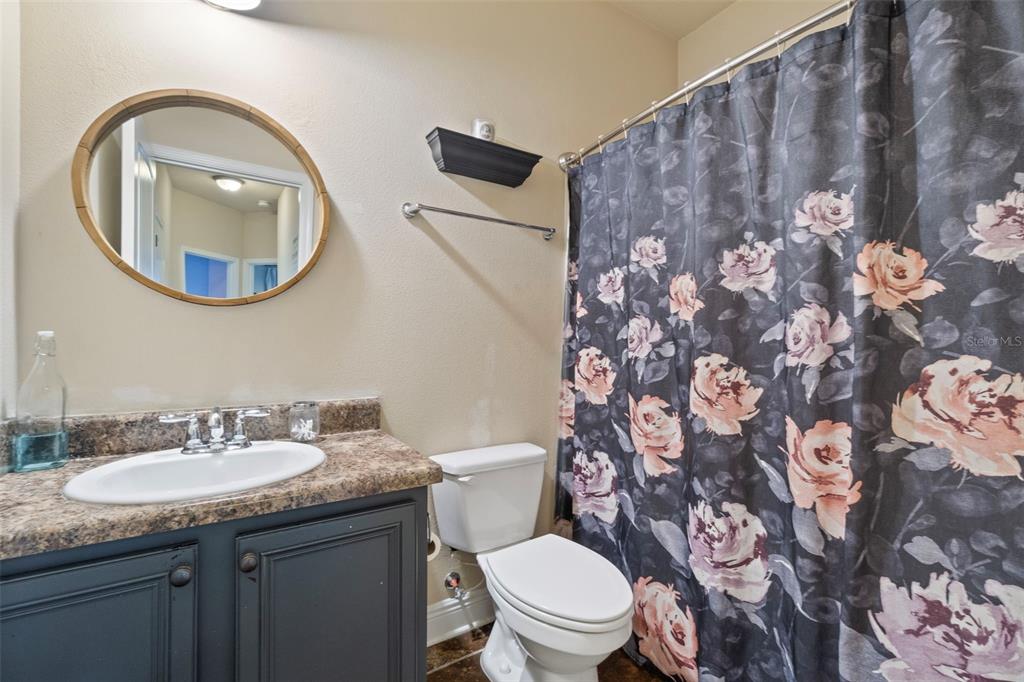 5973 Rustic Ridge Circle Milton, FL 32570 - Photo 14 of 44 a bathroom with a granite countertop toilet and a sink
