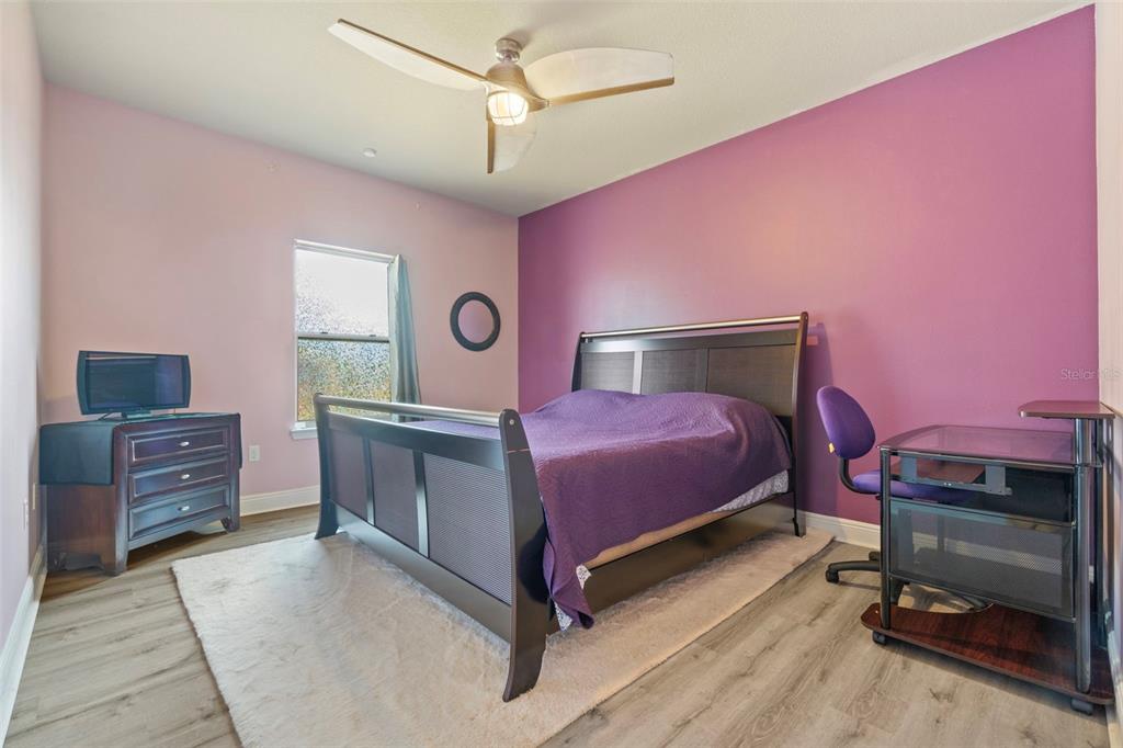 5973 Rustic Ridge Circle Milton, FL 32570 - Photo 15 of 44 a bedroom with a bed and a dresser in it