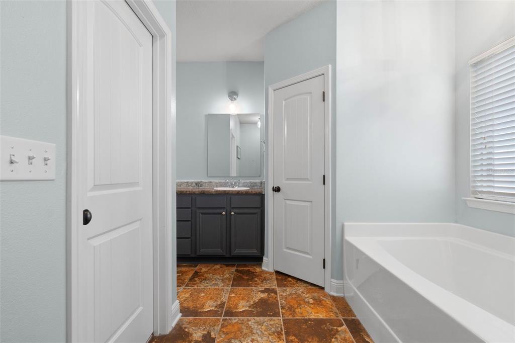 5973 Rustic Ridge Circle Milton, FL 32570 - Photo 19 of 44 a bathroom with a tub shower and sink