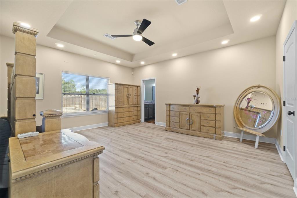 5973 Rustic Ridge Circle Milton, FL 32570 - Photo 23 of 44 a view of a livingroom with furniture wooden floor a ceiling fan and windows