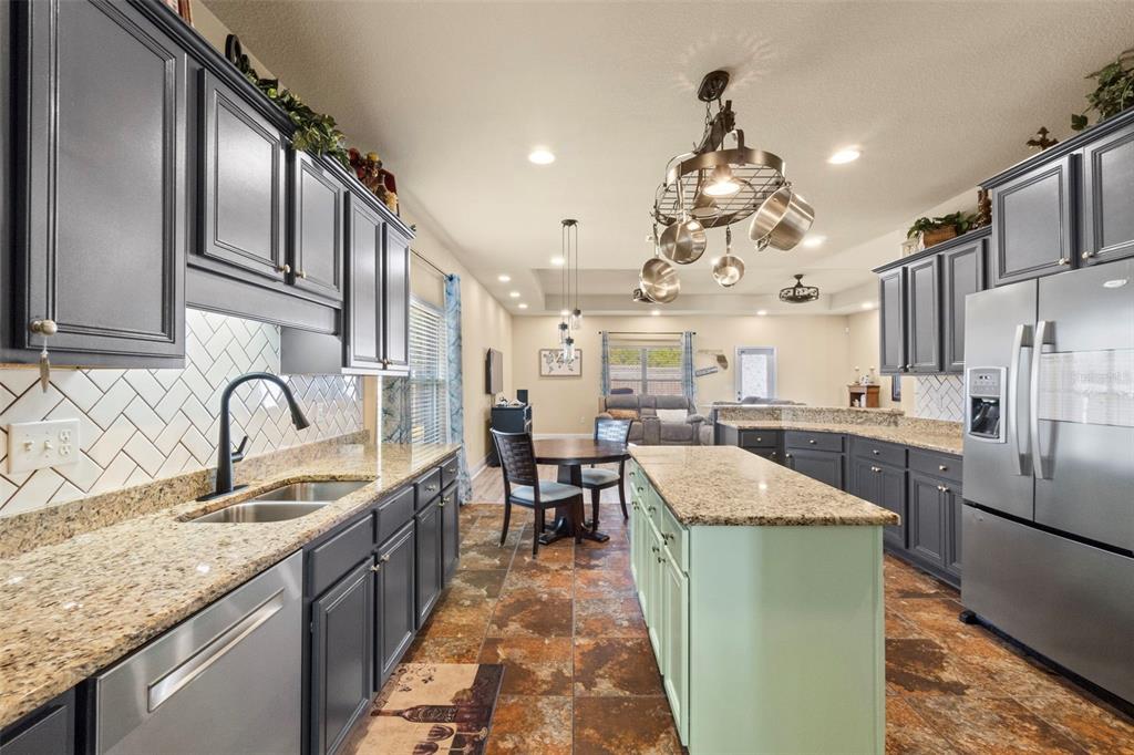 5973 Rustic Ridge Circle Milton, FL 32570 - Photo 26 of 44 a kitchen with cabinets a sink and appliances