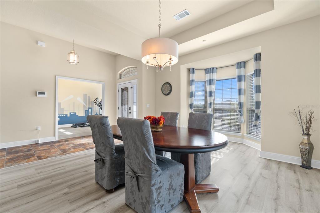 5973 Rustic Ridge Circle Milton, FL 32570 - Photo 39 of 44 a view of a dining room with furniture and wooden floor