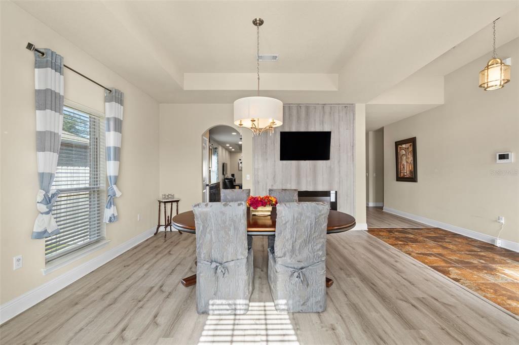 5973 Rustic Ridge Circle Milton, FL 32570 - Photo 40 of 44 a dining room with furniture a chandelier and wooden floor