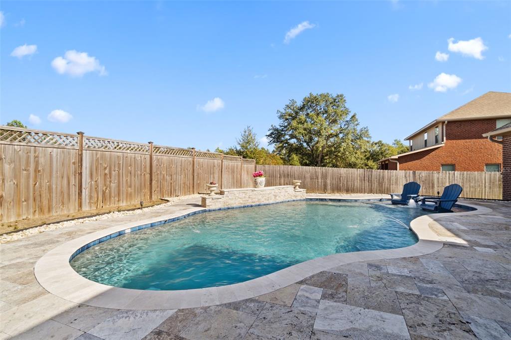 5973 Rustic Ridge Circle Milton, FL 32570 - Photo 7 of 44 a swimming pool with outdoor seating and yard