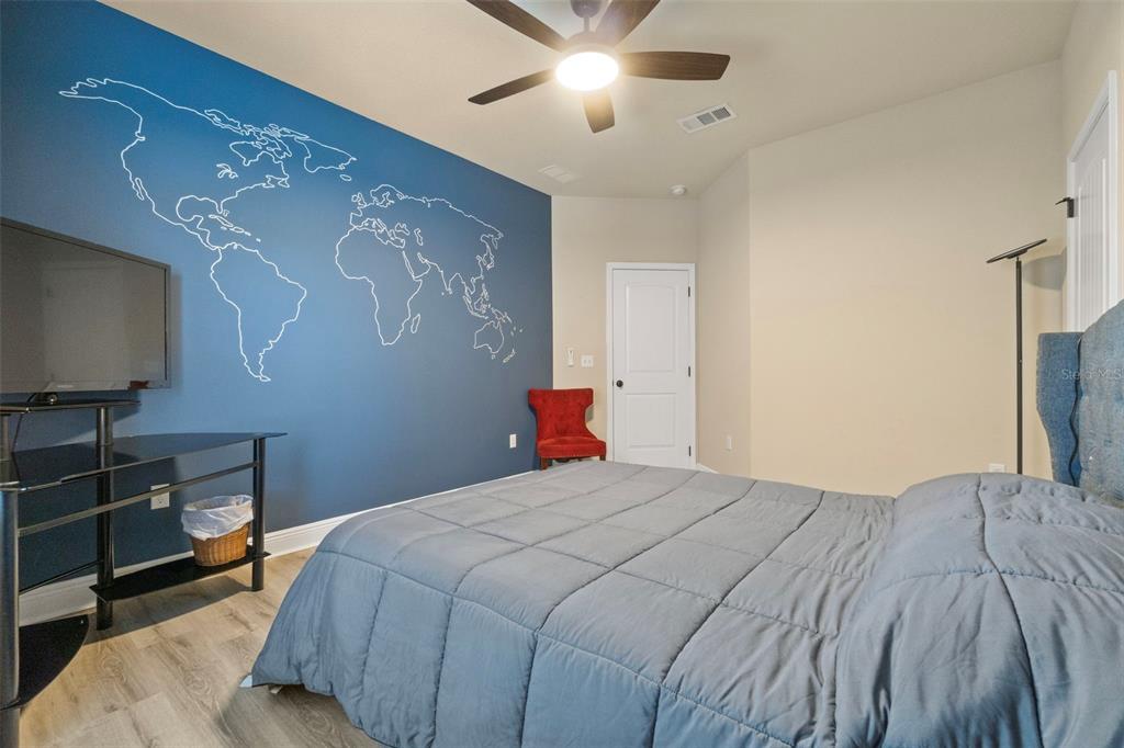 5973 Rustic Ridge Circle Milton, FL 32570 - Photo 10 of 44 a bedroom with a bed and a flat screen tv