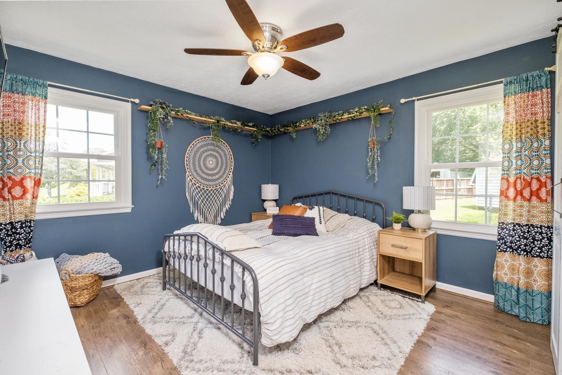 50 Valley Road Ruckersville, VA 22968 - Photo 17 of 39 a bedroom with a bed and a chandelier