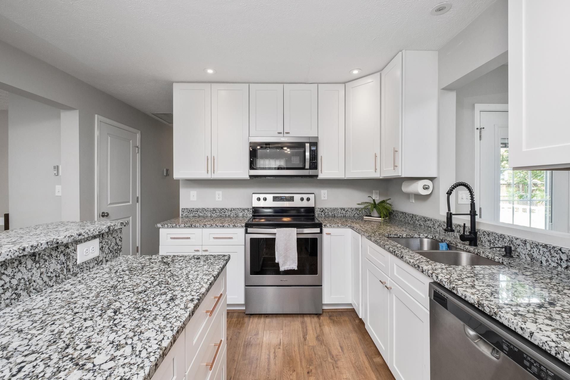 50 Valley Road Ruckersville, VA 22968 - Photo 2 of 39 a kitchen with stainless steel appliances granite countertop a sink stove and microwave